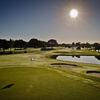 A view of green guarded by bunkers and water at Flamingo Lakes Golf & Country Club 